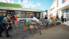 Toys for Tots 2024 Organizers bring shopping carts full of toys to a CTfastrak bus as donations.