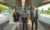 Community partners including representatives from THOP, the Connecticut State Police, and CTtransit walk the guideway on CTfastrak.
